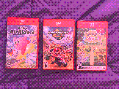 switch 2 games! in order: kirby air riders, mario kart world and pokemon pokopia on my bed